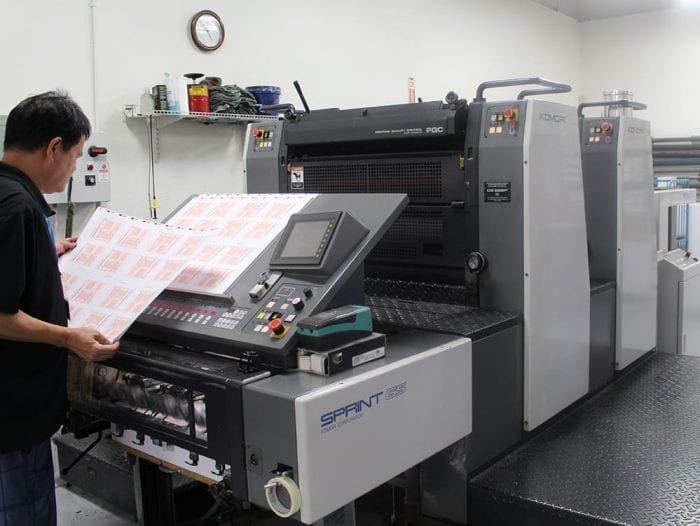 production team on komori press